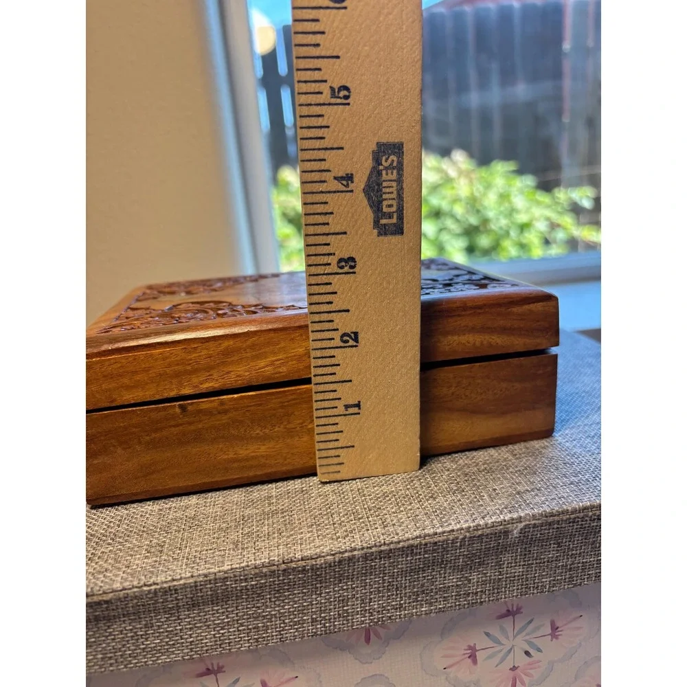 Handmade wooden jewelry box with a brass inlay and hand-carved floral design